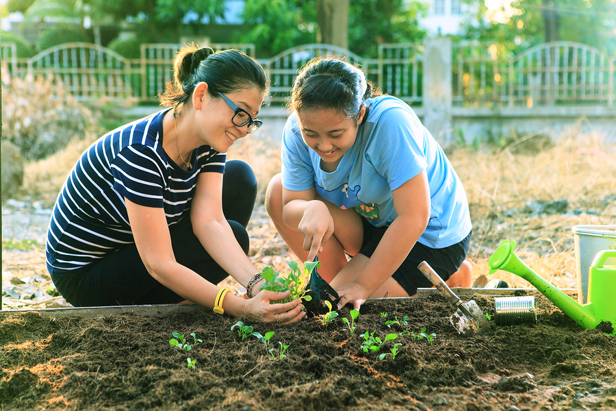 Sister's planting a garden together