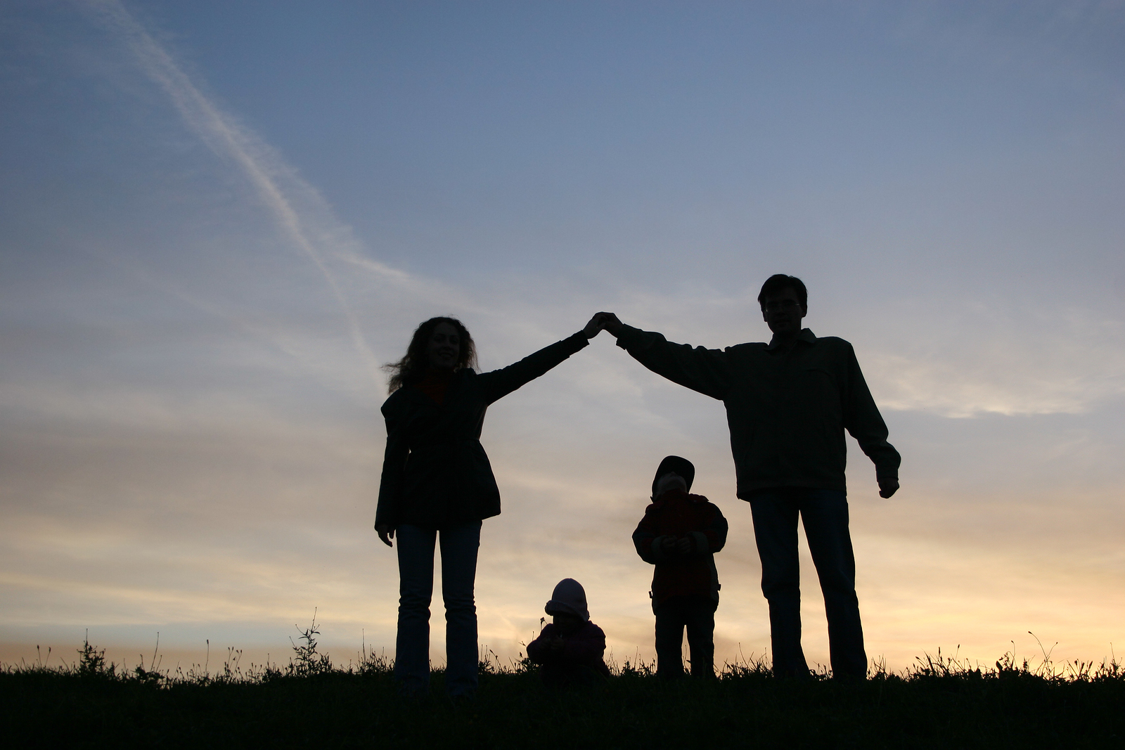 Four people in shadow against the sunset