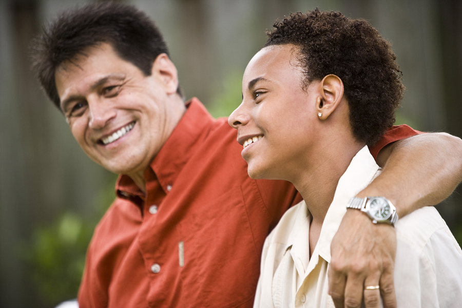 man giving and arm hug to his adult daughter