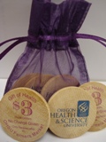 bag of $3 wooden tokens with purple writing