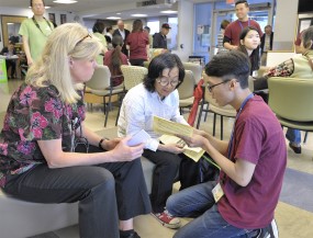 Linda Paul,of the OHSU School of Nursing and faculty (left) waits as Tin Huynh (right), a Vietnamese speaking volunteer, interprets information to a Vietnamese client at the 2017 Asian Community Health Fair.
