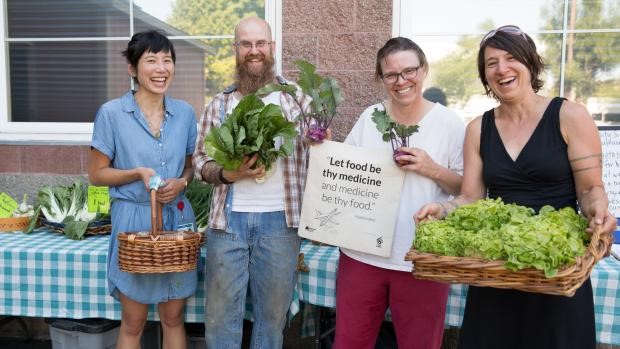 Zenger Farm farm share team poses at the Southeast Portland pick-up site. From left, OHSU Jennifer Tsai, farmer Scott Suzadail, and county staffers Carla Remeschatis and Katy Pranian.